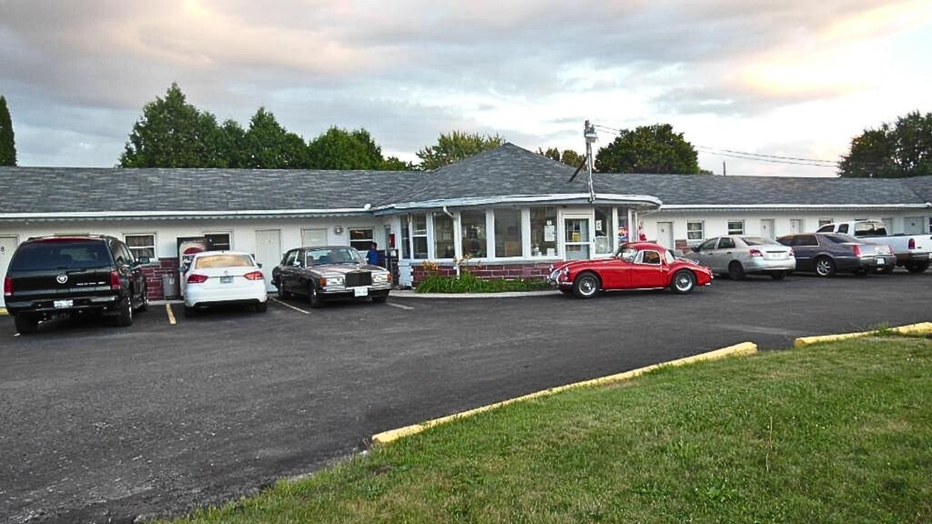 Motel with parked cars and greenery